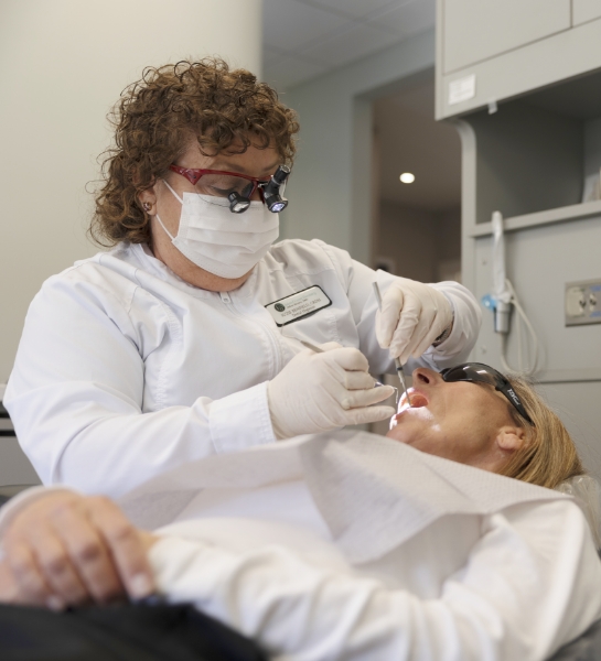 Dental team member examining dentistry patient