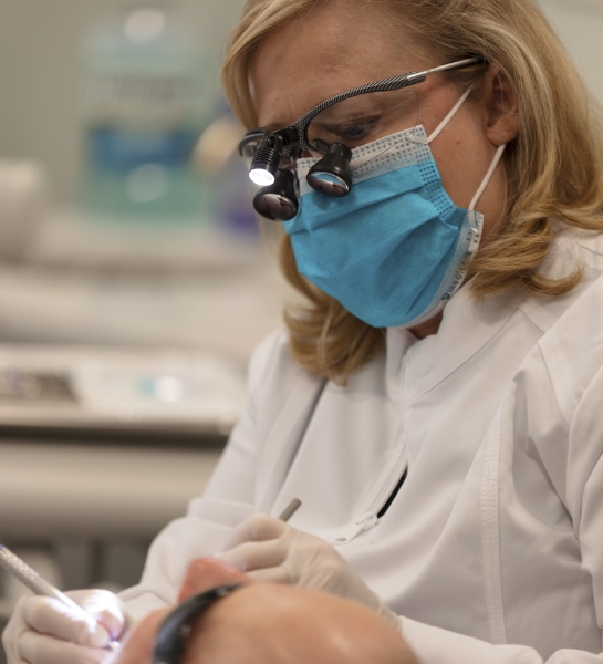 Dental team member treating dental patient