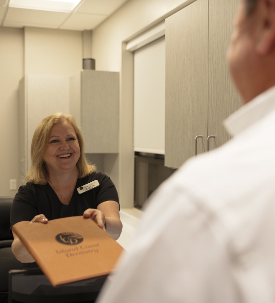 Dental team member giving dentistry patient flexible payment options