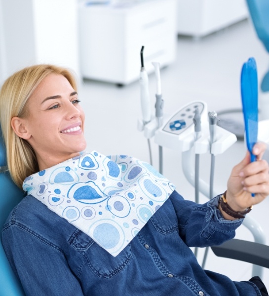 Patient looking at smile after dental cleaning