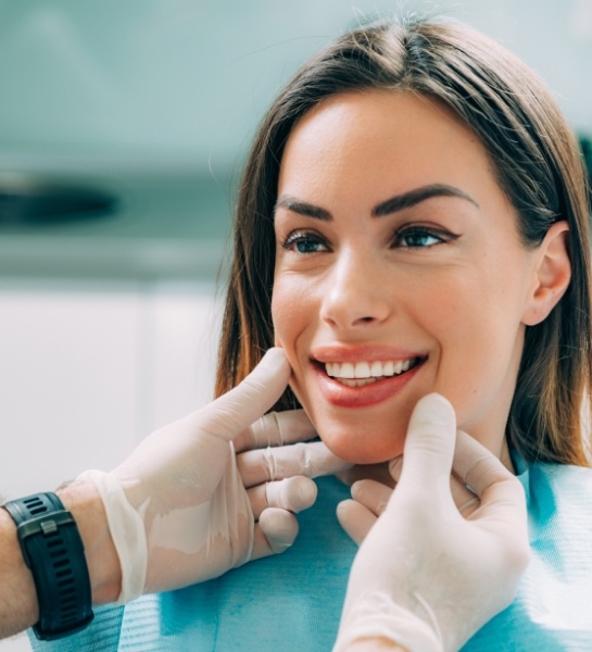 Dentist examining patient's smile during dental cleaning