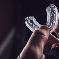 hand holding a mouthguard