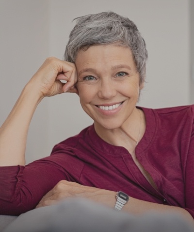 Woman in red blouse grinning