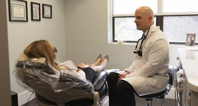 Dentist in Naples Florida talking to dental patient