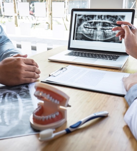 Dentist using digital x-rays to explain the cost of smile makeovers