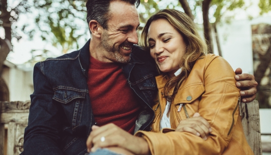 Man and woman sharing healthy smiles after preventive dentistry