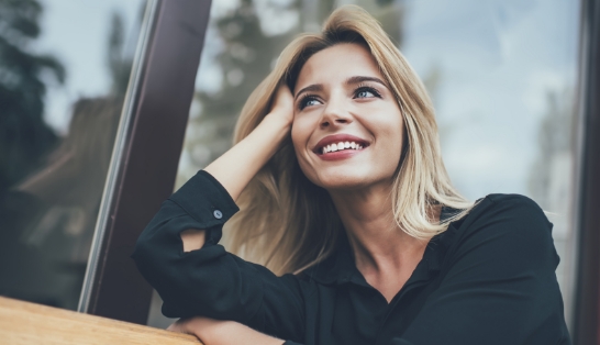 Woman with perfectly aligned smile after orthodontic treatment