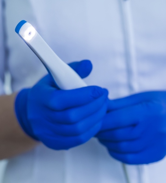 Dentist holding intraoral camera