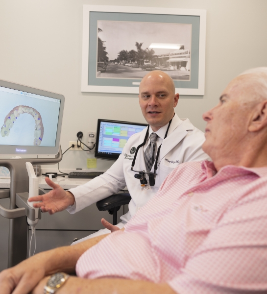 Dentist and patient looking at digital x-rays