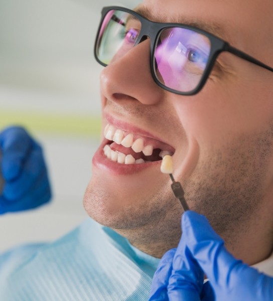 Man smiling after getting veneers in Naples