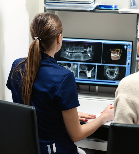 Dental team members reviewing digital dental x-rays
