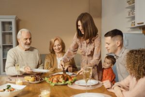 Man eating with dental implants at Thanksgiving dinner.