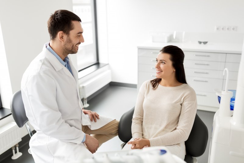 woman learning about the benefits of porcelain veneers