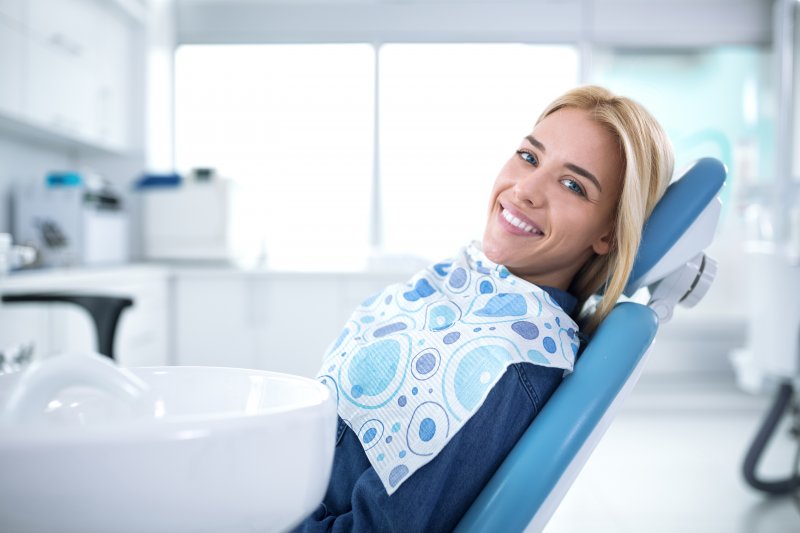 person smiling at dentist after receiving gum disease therapy