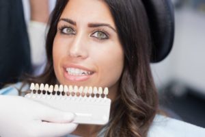 dentist color-matching porcelain veneers