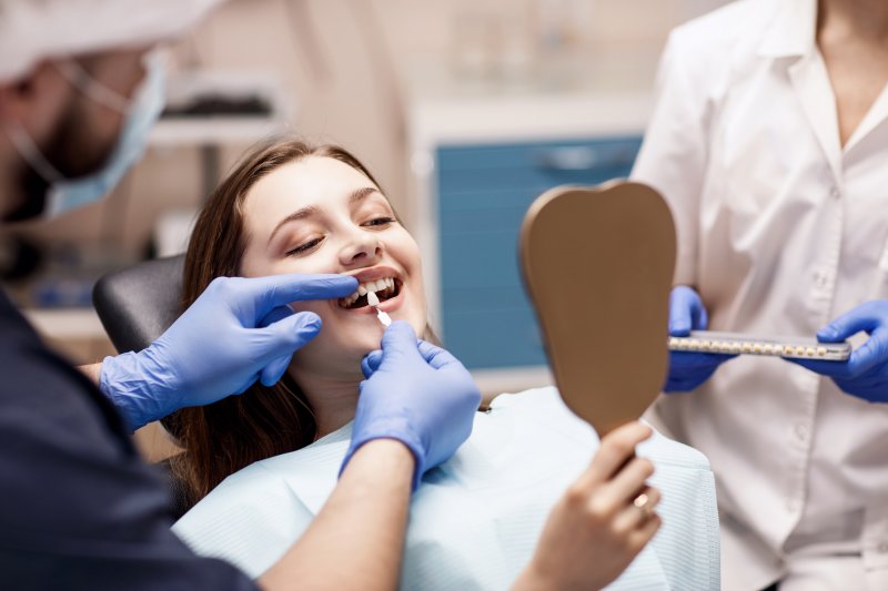 A cosmetic dentist working on a patient’s smile