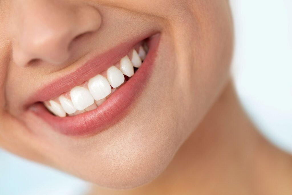 Nose-to-neck closeup of woman smiling